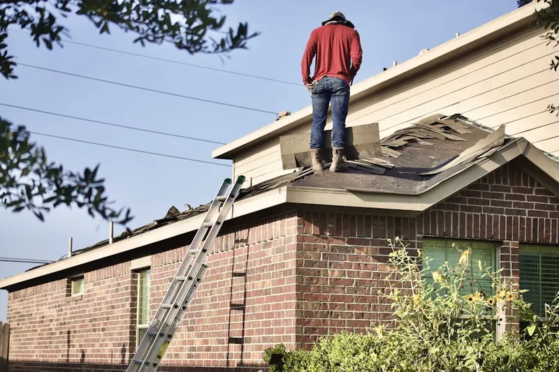 Professional roofer working on a residential roof in North Oak Park